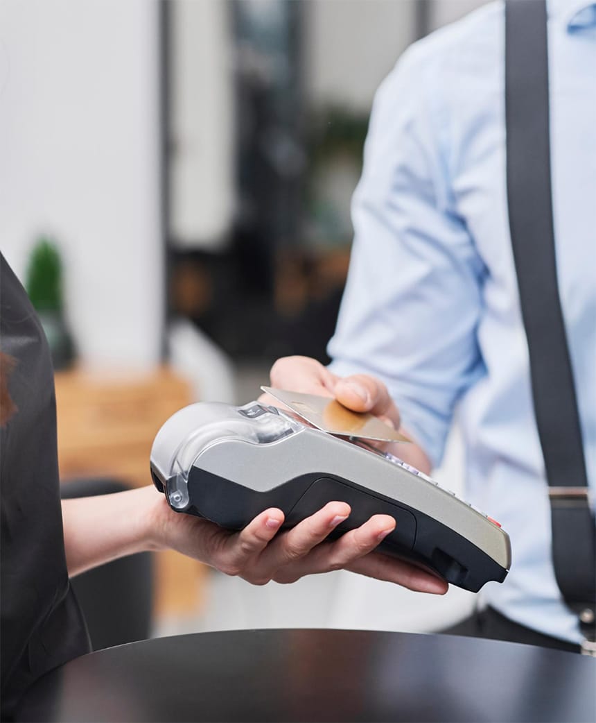 customer paying for a haircut on credit card terminal