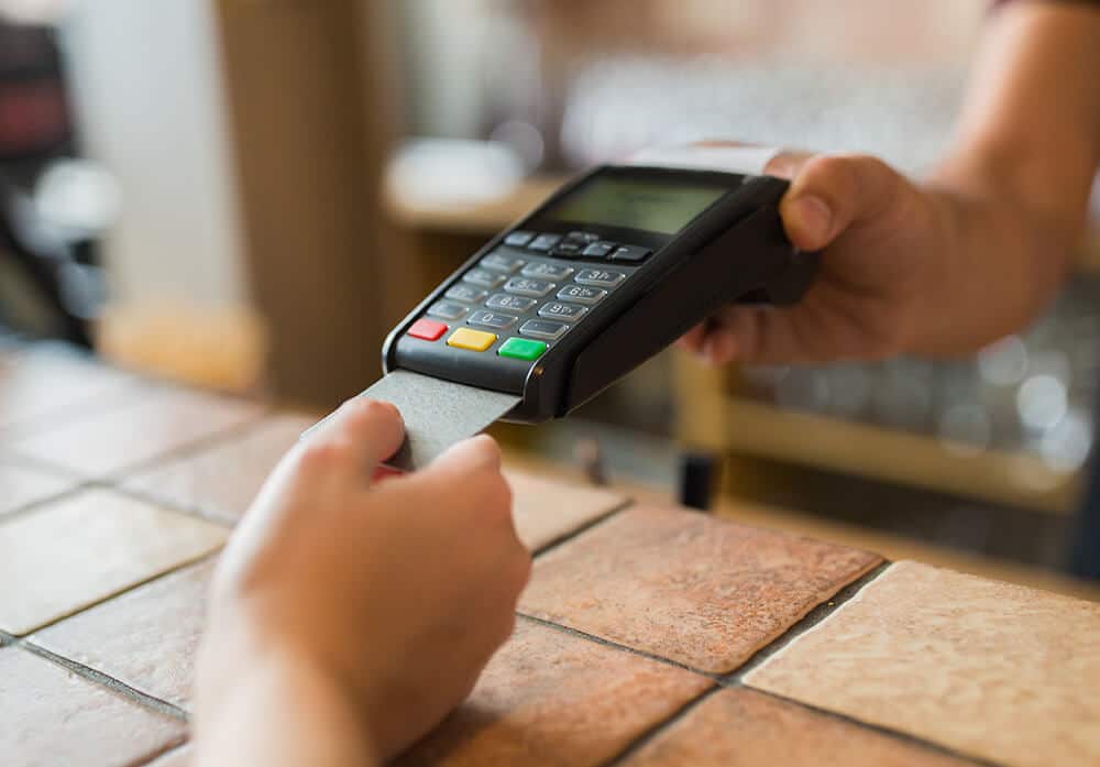 customer paying with credit card on the payment terminal