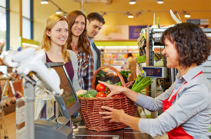customers paying at the check out in a retail store
