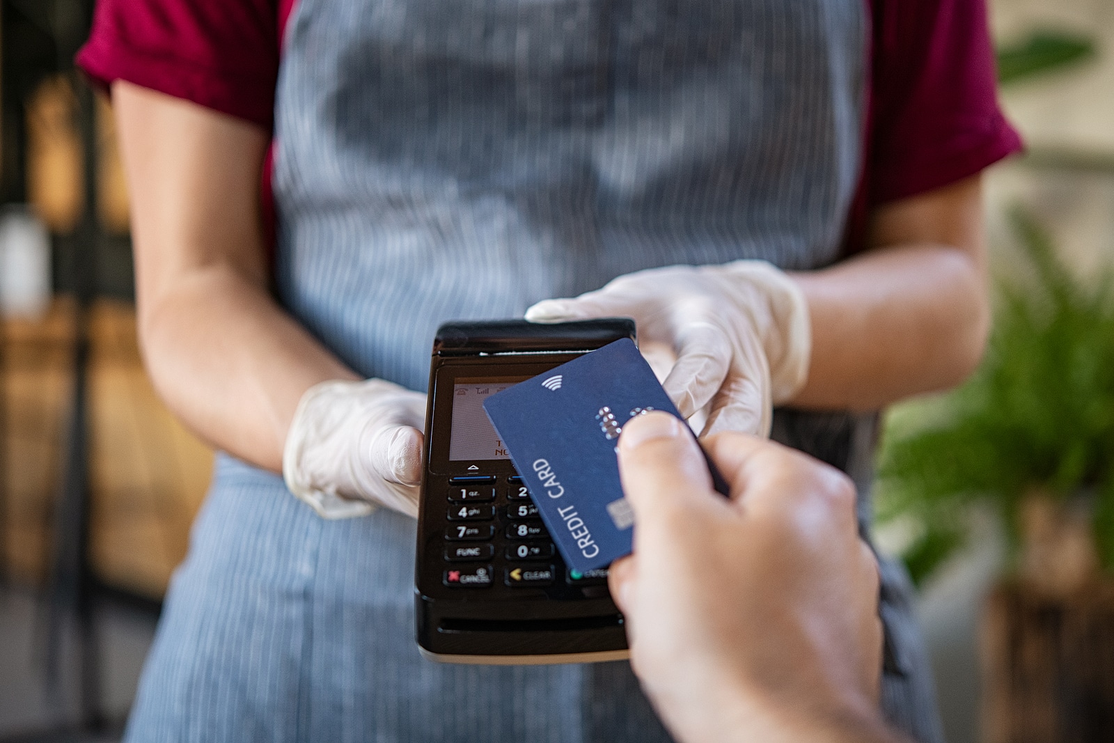 customer paying with contactless credit card with NFC technology